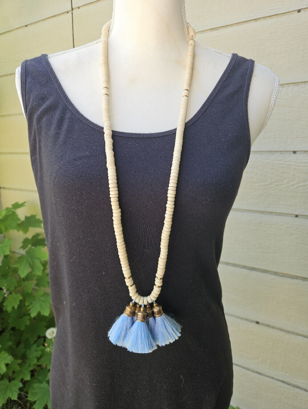 light wood necklace with blue tassels